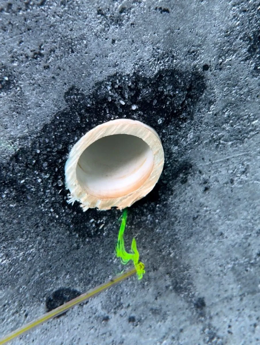 Using a dye needle to test a swimming pool for a leak