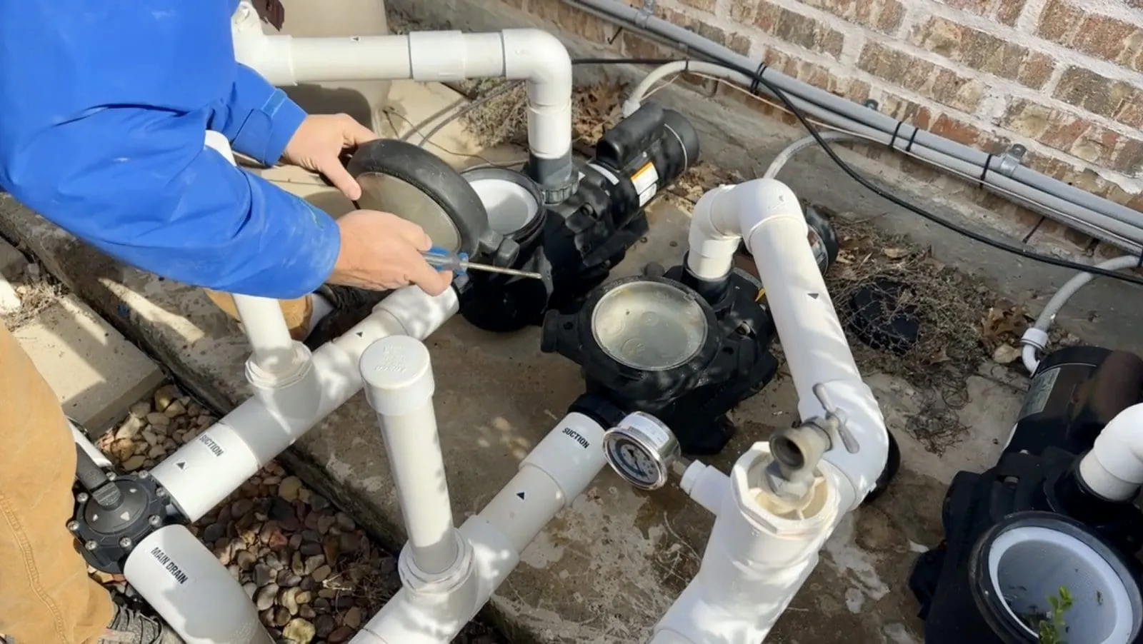 Taking off the pump lid to winterize pool equipment