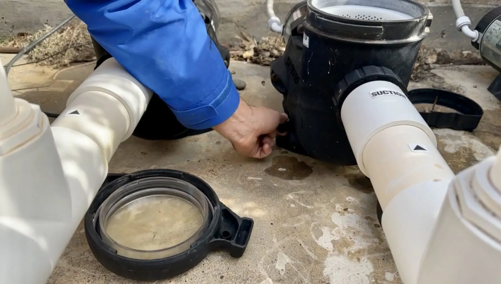Taking out a pool pump plug to drain the pump for winterizing