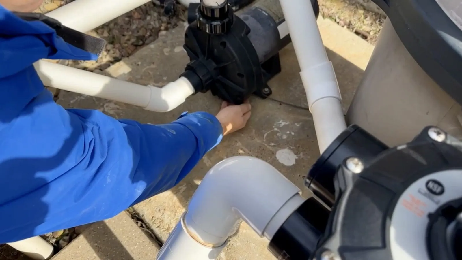 Removing the plug from a pool booster pump for winterization