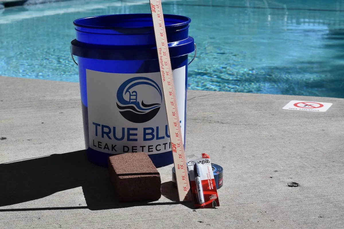 Bucket test equipment needed: bucket, ruler, tape, pen, and brick